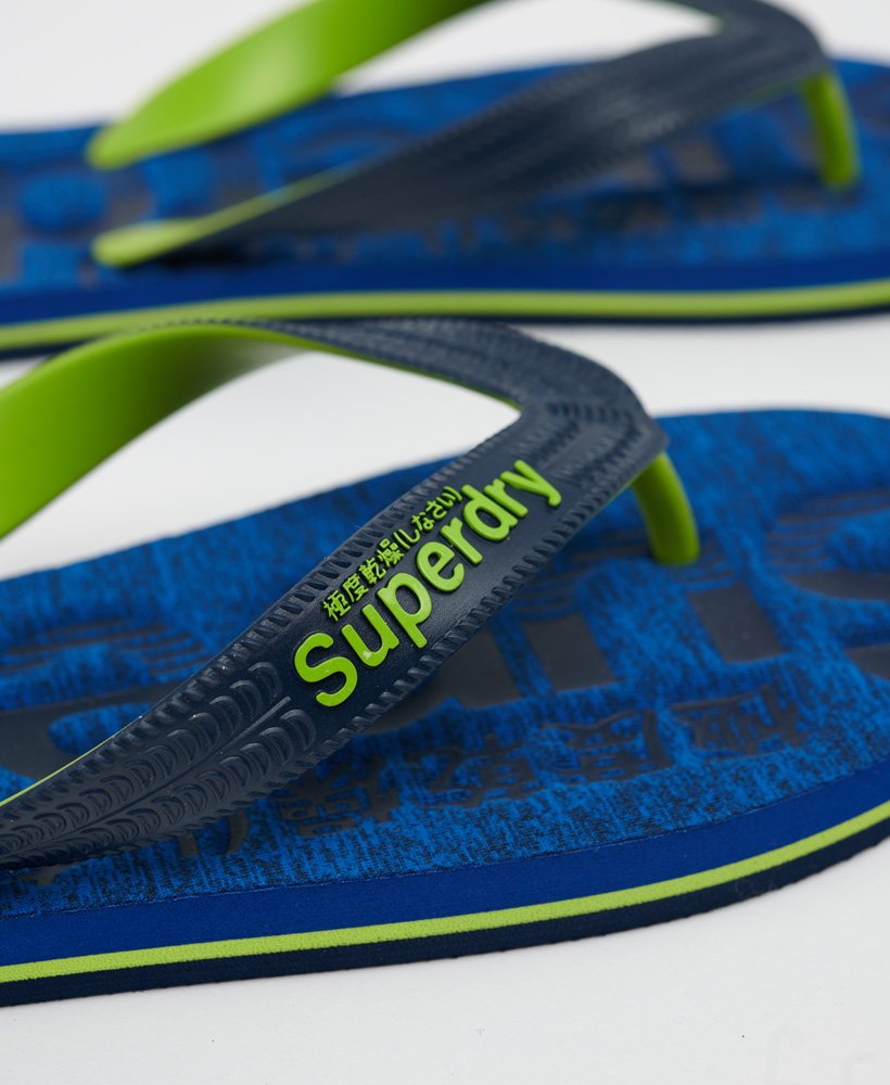 essential logo flip flops in cobalt grid