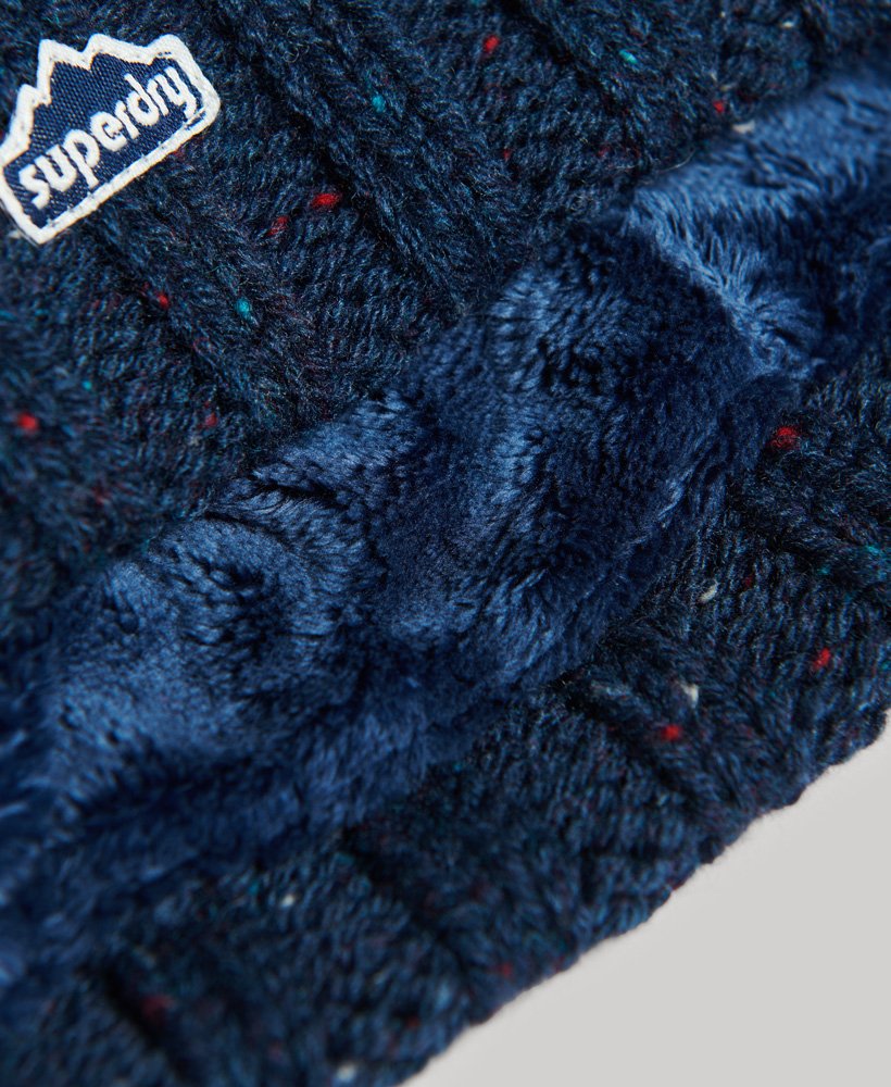 kabelgebreide muts met pompon in donkerblauw tweed