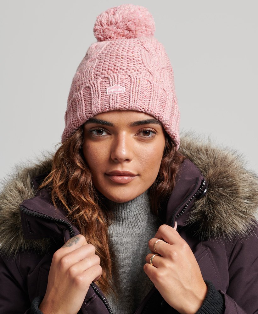 kabelgebreide muts met pompon in roze tweed