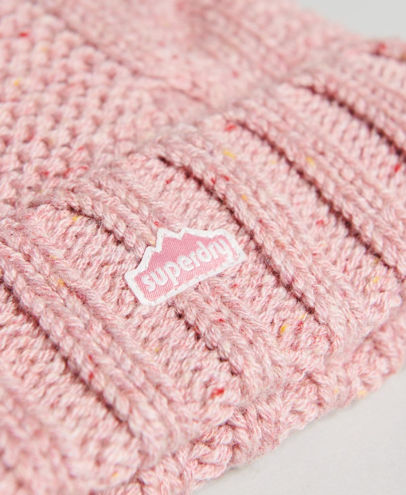 kabelgebreide muts met pompon in roze tweed